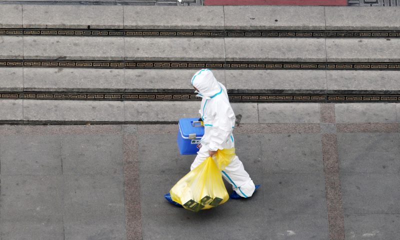 The photo taken on August 13, 2022 shows an anti-epidemic worker in Urumqi, Northwest China