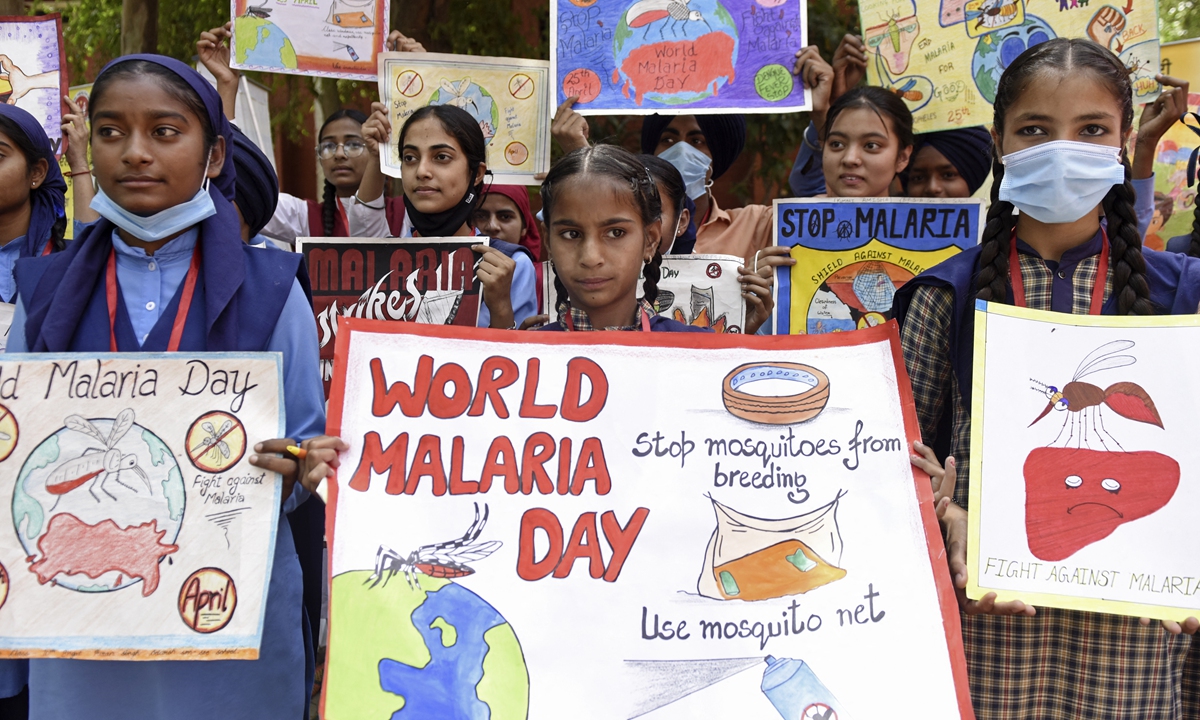 Students hold placards during an event to mark the World Malaria Day at a government hospital on the outskirts of Amritsar, India on April 25, 2022. Malaria remains a deadly disease around the world, primarily affecting children below the age of 5. In Southeast Asia, India is bearing the brunt, accounting for 80 percent of the region
