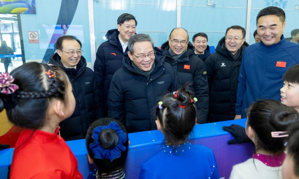 Chinese Premier Li Qiang, also a member of the Standing Committee of the Political Bureau of the Communist Party of China Central Committee, communicates with children at a local ice sports center in Harbin, northeast China