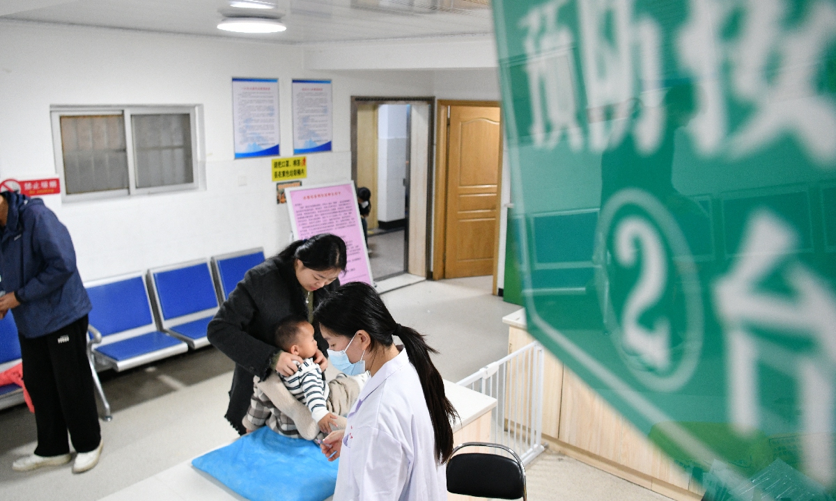 Medical staff at the Funan County Center for Disease Control and Prevention in Fuyang City, Anhui Province, provide autumn and winter flu vaccinations to young children on October 25, 2025. Photo: VCG

