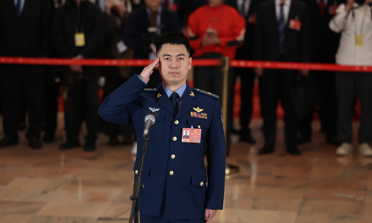 NPC deputy and J-16 pilot Wang Wenyi from a PLA Air Force aviation brigade attends the first