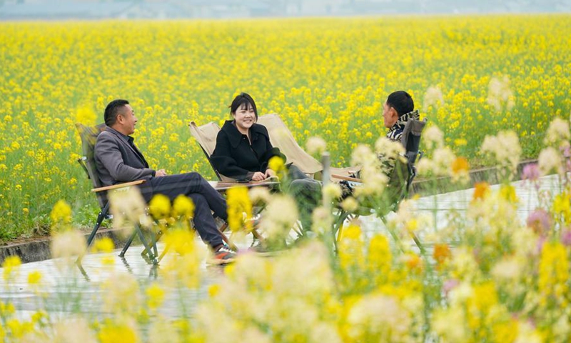 Tourists enjoy leisure time among blooming flowers at Pengshan District of Meishan, southwest China