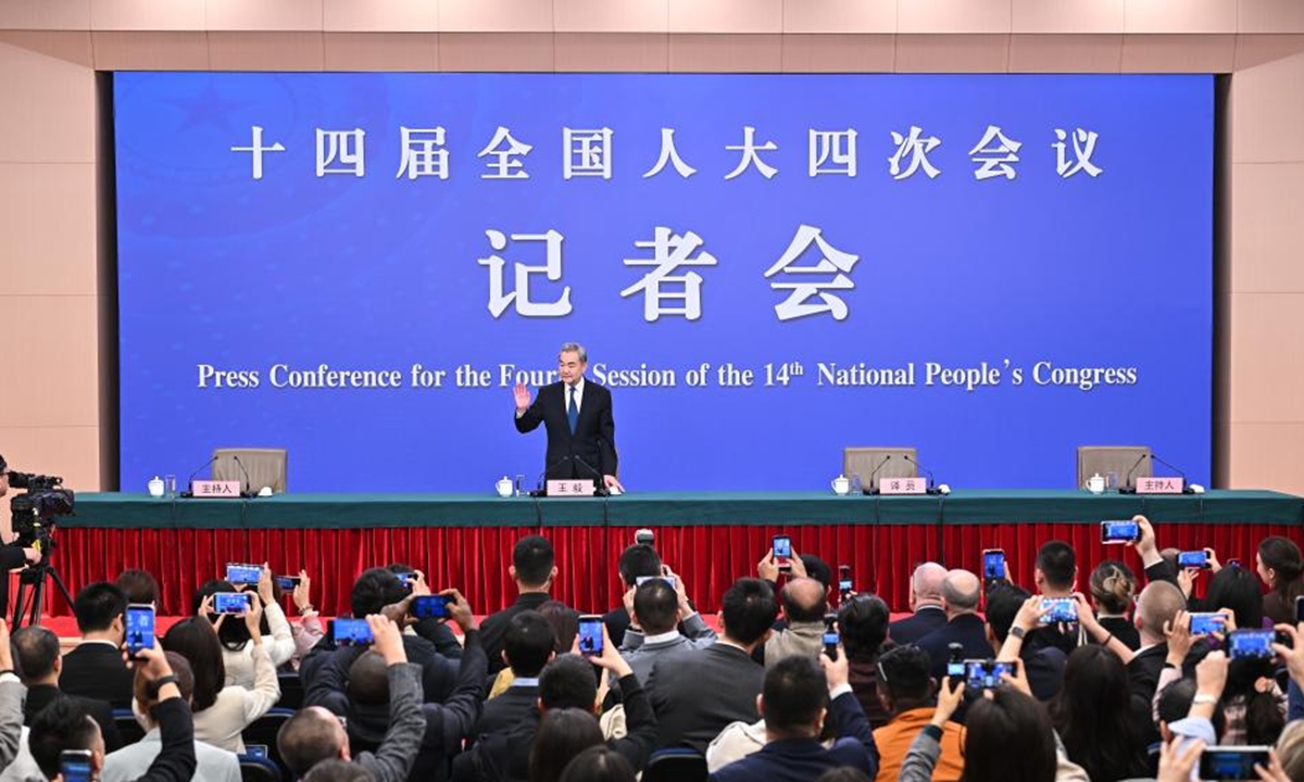Chinese Foreign Minister Wang Yi, also a member of the Political Bureau of the Communist Party of China Central Committee, attends a press conference on China