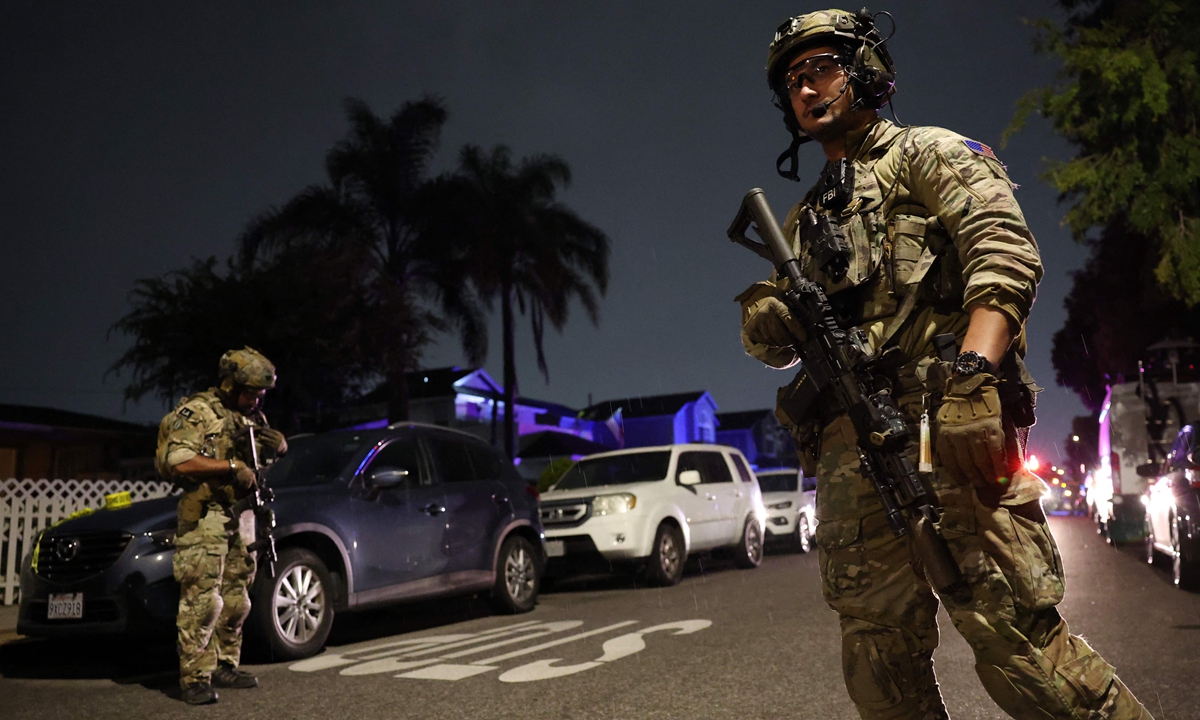 An FBI tactical team prepares to enter a house associated with the suspected White House Correspondents