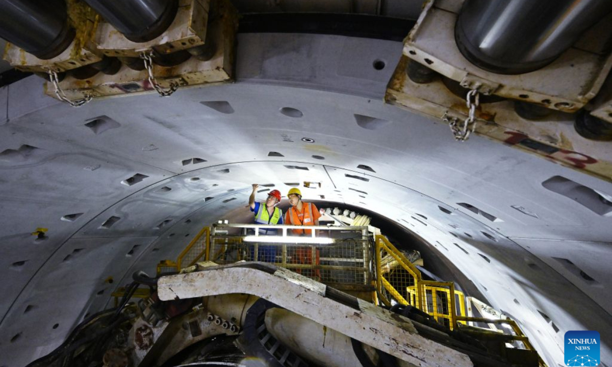 Constructors make a safety inspection at the construction site of Qingdao Jiaozhou Bay Second Tunnel in Qingdao, east China